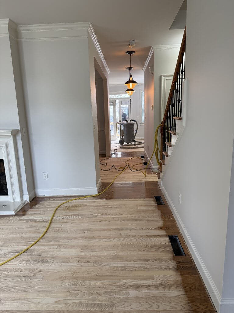 Newly installed wide plank hardwood with clean trim detail Newly installed wide plank hardwood with clean trim detail