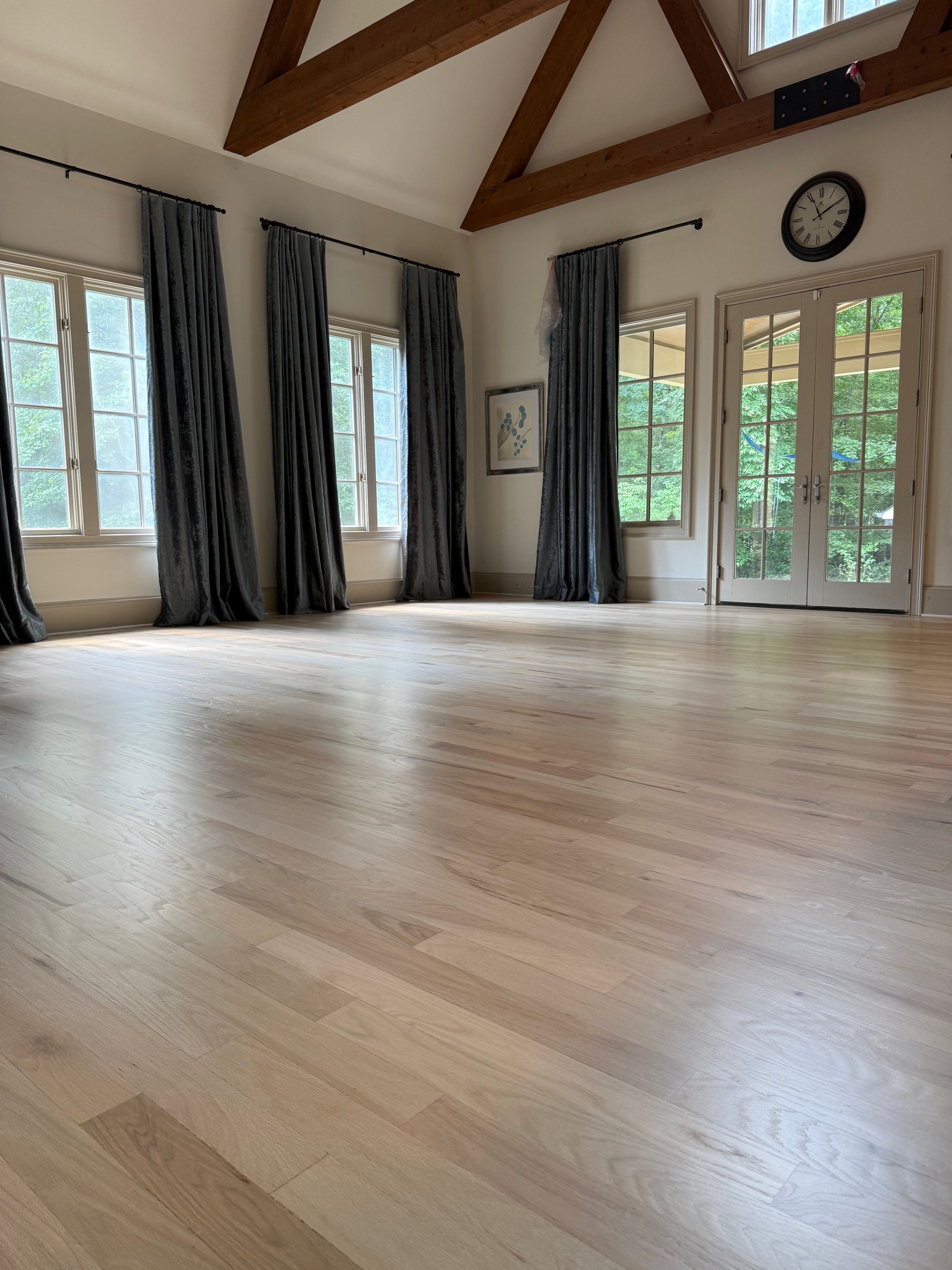 Refinished white oak hardwood floor in a vaulted great room — a recent Cumming Floors project
