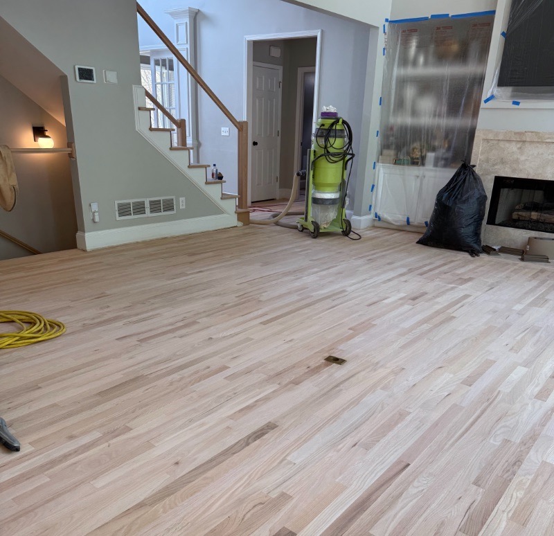 Red oak floor mid-sanding with dust-containment equipment