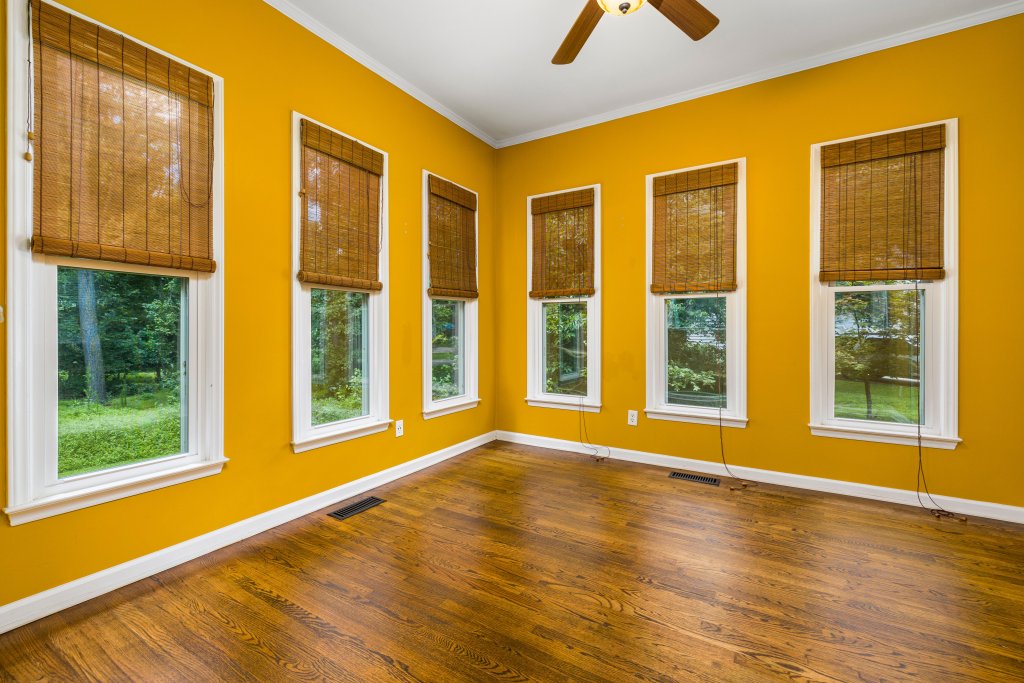Spacious room with wooden floors and large windows
