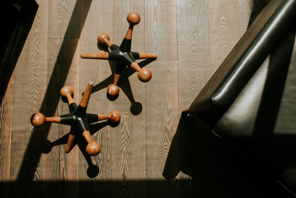 Office chair bases on a polished wooden floor