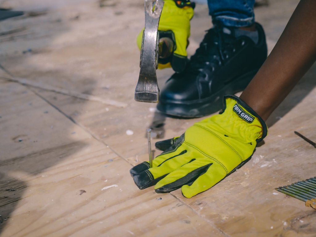Worker using a hammer on plywood