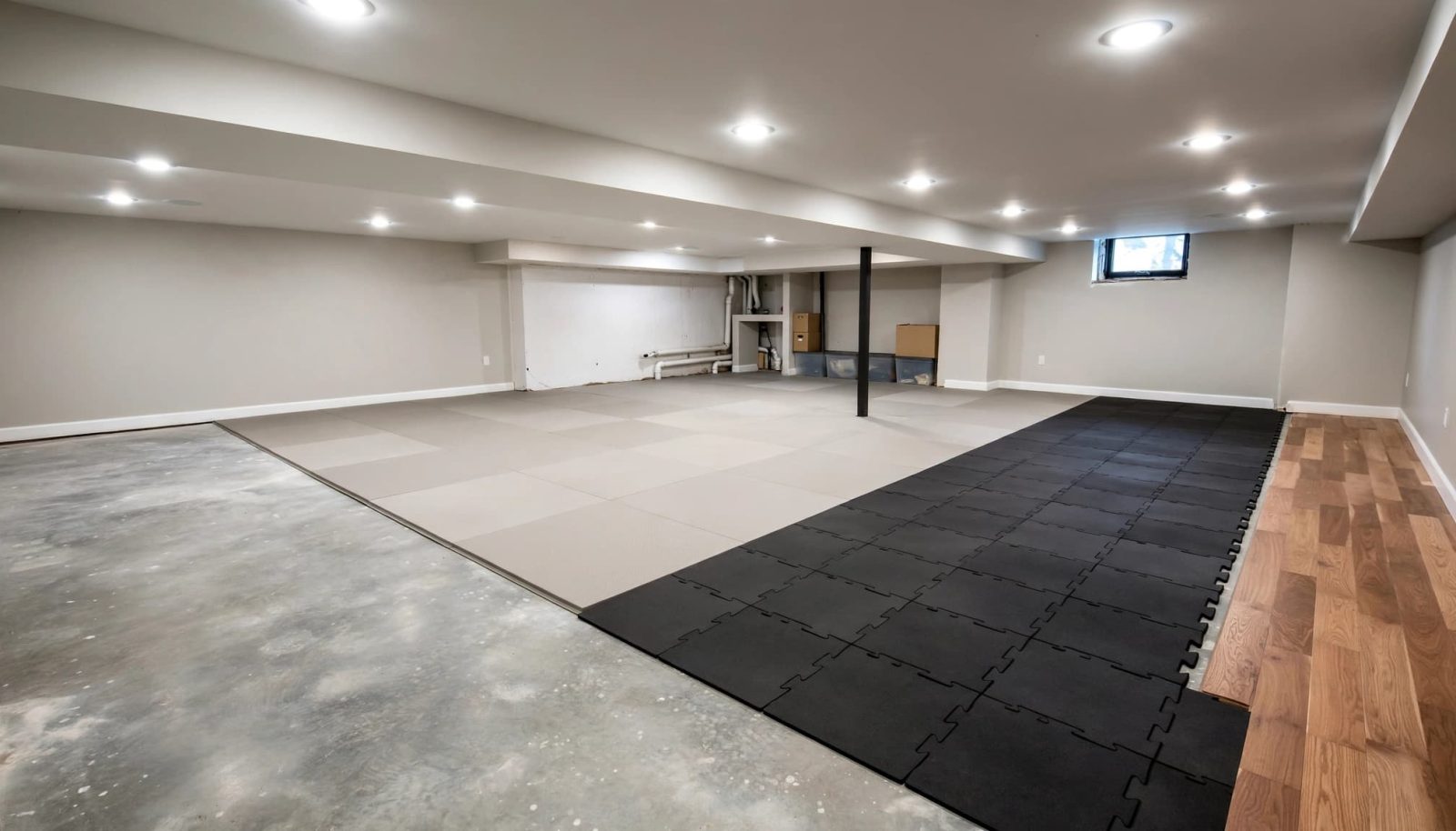 Finished basement with rubber and foam flooring beside a small wood floor section.